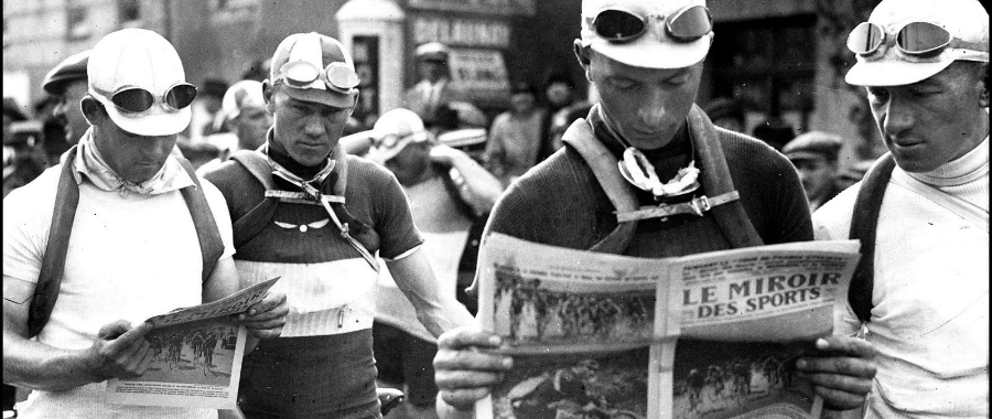 Cyclists readdijg newspaper during the Tour de France in the 1920s