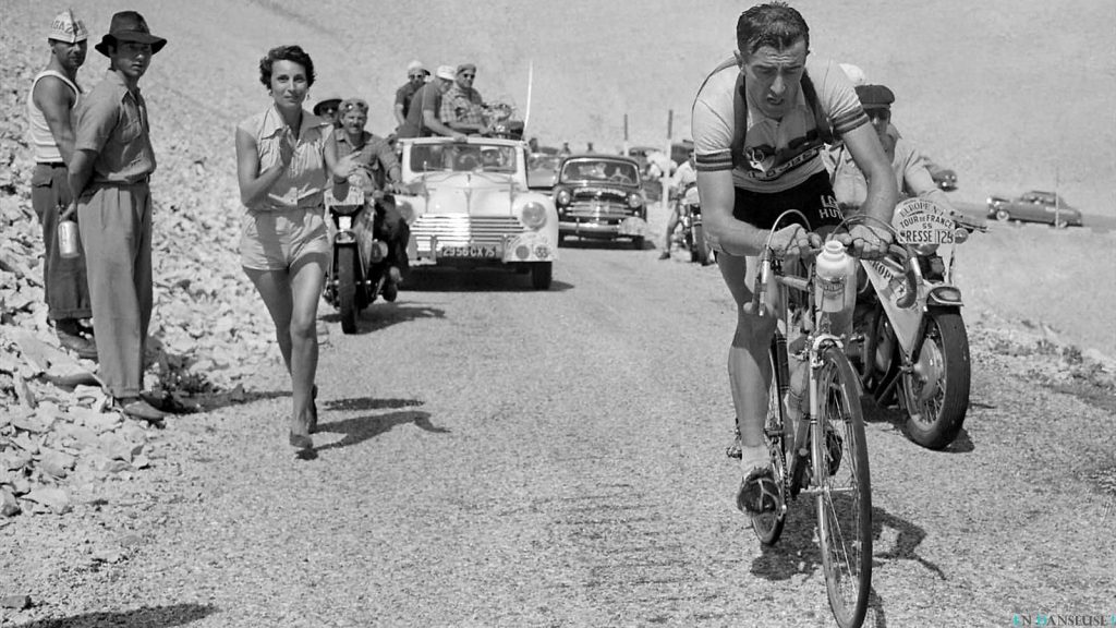 Louison Bobet climbing Mont Ventoux while his wife Christiane rinning alongside him during Tour de France 1955