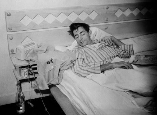 A classic and iconic vintage cycling image depicting Italian cycling legend Fausto Coppi lying in the bed together with the yellow jersey of Tour de France