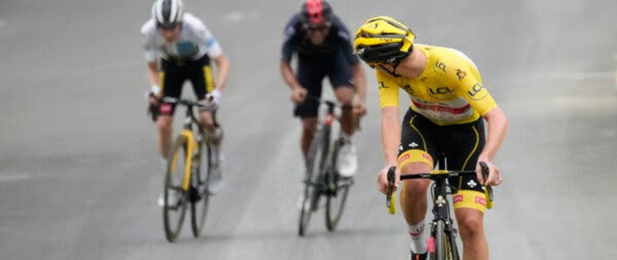 Tadej Pogacar attacking in the Pyrenees during Tour de France 2021 while looking back at his rivals
